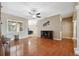 Cozy living room with hardwood floors, a ceiling fan, and a faux fireplace feature at 9127 Irondale Ln, Hudson, FL 34667