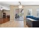Open living room with hardwood floors, sliding glass doors to patio, and decorative chandelier at 9127 Irondale Ln, Hudson, FL 34667