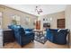 Living room with bright blue furniture, tile floors, neutral paint, and lots of natural light at 9127 Irondale Ln, Hudson, FL 34667