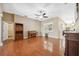 Spacious living room with beautiful hardwood floors, piano, and neutral paint at 9127 Irondale Ln, Hudson, FL 34667