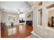 Bright and airy living room with hardwood floors, decorative columns, and a cozy fireplace at 9127 Irondale Ln, Hudson, FL 34667