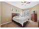 Bright main bedroom with a ceiling fan, large window, and dresser furniture at 9127 Irondale Ln, Hudson, FL 34667
