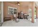 Enclosed patio with ceiling fan, furniture, punching bag, and grill at 9127 Irondale Ln, Hudson, FL 34667