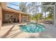 Covered screened-in pool area with a plunge pool and furniture at 9127 Irondale Ln, Hudson, FL 34667
