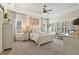 Relaxing main bedroom boasts tray ceiling, shutters, neutral paint, ceiling fan, and carpet flooring at 922 Grand Cresta Ave, Brandon, FL 33511