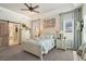 Spacious bedroom showcases wood-look barn door, chair rail molding, ceiling fan, and large windows at 922 Grand Cresta Ave, Brandon, FL 33511