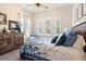 Relaxing bedroom features a ceiling fan, rustic furniture, and ample natural light at 922 Grand Cresta Ave, Brandon, FL 33511