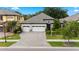 Beautiful one-story home with three-car garage, paver driveway, stone accents, and well-maintained landscaping at 922 Grand Cresta Ave, Brandon, FL 33511