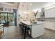Bright and airy kitchen featuring a large island, modern appliances, and access to the pool area at 922 Grand Cresta Ave, Brandon, FL 33511