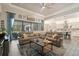 Spacious living room with a large leather couch, ceiling fan, and backyard views at 922 Grand Cresta Ave, Brandon, FL 33511
