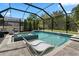 A luxurious screened in swimming pool with mosaic tile work and a lounge chair, perfect for relaxation and recreation at 922 Grand Cresta Ave, Brandon, FL 33511