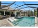 A luxurious screened in swimming pool with in-pool lounge chairs and a hot tub, perfect for relaxation and recreation at 922 Grand Cresta Ave, Brandon, FL 33511