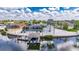 Aerial view of a waterfront home with boat dock, screened lanai and beautiful landscaping at 927 Golf Island Dr, Apollo Beach, FL 33572