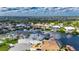 Expansive aerial shot of a waterfront home with a private dock, surrounded by beautiful scenery and calm waterways at 927 Golf Island Dr, Apollo Beach, FL 33572