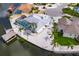 Charming waterfront home featuring a screened pool, boat lift, and meticulous landscaping with palm trees at 927 Golf Island Dr, Apollo Beach, FL 33572
