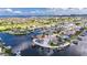Expansive aerial shot of a waterfront home with a private dock, surrounded by beautiful scenery and calm waterways at 927 Golf Island Dr, Apollo Beach, FL 33572