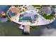 Stunning aerial view of waterfront home with a screened pool and a private boat dock at 927 Golf Island Dr, Apollo Beach, FL 33572