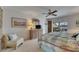 Bright bedroom featuring a ceiling fan, soft carpet, and a sliding door leading to a screened lanai at 927 Golf Island Dr, Apollo Beach, FL 33572