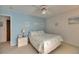 Cozy bedroom with blue walls, a patterned bedspread, and framed beach-themed pictures at 927 Golf Island Dr, Apollo Beach, FL 33572
