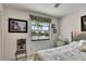 Bedroom with waterfront view showcasing a palm tree framed by a window with a decorative valance at 927 Golf Island Dr, Apollo Beach, FL 33572