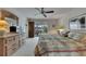 This bedroom features a ceiling fan, plush carpet, and access to a screened-in patio at 927 Golf Island Dr, Apollo Beach, FL 33572