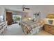 This bedroom features soft carpet, a ceiling fan, and access to the screened-in lanai at 927 Golf Island Dr, Apollo Beach, FL 33572