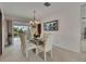 Formal dining area with a glass table, stylish chairs, and a modern chandelier, perfect for entertaining at 927 Golf Island Dr, Apollo Beach, FL 33572