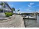 Scenic view of the dock and boat lift providing direct access to the water and beautiful landscaping at 927 Golf Island Dr, Apollo Beach, FL 33572