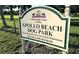 Close up of Apollo Beach Dog Park sign with county logo and park information at 927 Golf Island Dr, Apollo Beach, FL 33572