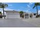 Inviting home with a two-car garage, low maintenance yard, mature palm trees, and an attractive gated entry at 927 Golf Island Dr, Apollo Beach, FL 33572