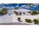Charming home featuring a well-manicured, low maintenance yard, a two-car garage, and decorative gated entry at 927 Golf Island Dr, Apollo Beach, FL 33572