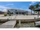 Exterior showcasing a waterfront home with lush landscaping, a boat dock and a screened lanai at 927 Golf Island Dr, Apollo Beach, FL 33572