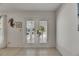 Bright foyer featuring tiled flooring and a view of the decorative glass front doors, adding to the home's appeal at 927 Golf Island Dr, Apollo Beach, FL 33572