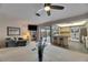 Open living space with a view of the outdoor pool, featuring comfortable seating and a kitchen bar area at 927 Golf Island Dr, Apollo Beach, FL 33572