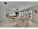 Bright and airy living room with large windows, neutral tones, and a full mirrored wall, enhancing the sense of space at 927 Golf Island Dr, Apollo Beach, FL 33572