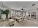 Bright living room featuring a ceiling fan, neutral color scheme, and natural light from multiple windows at 927 Golf Island Dr, Apollo Beach, FL 33572
