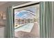 Long view of a screened-in pool featuring views of waterfront homes at 927 Golf Island Dr, Apollo Beach, FL 33572
