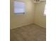 Bedroom with tile flooring, neutral walls, and a double window with horizontal blinds at 10817 Fillmore Ave, Port Richey, FL 34668