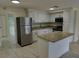Updated kitchen featuring granite countertops, stainless steel appliances, and white cabinets at 10817 Fillmore Ave, Port Richey, FL 34668