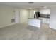 Open-concept living room and kitchen feature modern updates and an island with granite countertop at 10817 Fillmore Ave, Port Richey, FL 34668