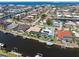 Aerial view showcasing waterfront neighborhood homes, many with private docks, swimming pools and screened lanais at 1137 Treasure Cay Ct, Punta Gorda, FL 33950