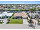 Beautiful aerial view of a waterfront home surrounded by lush landscaping and a tranquil canal at 1137 Treasure Cay Ct, Punta Gorda, FL 33950