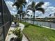 Beautiful waterfront backyard showcasing lush landscaping and private canal access at 1137 Treasure Cay Ct, Punta Gorda, FL 33950