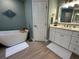 Elegant bathroom featuring a freestanding tub, white vanity, and neutral accents at 1137 Treasure Cay Ct, Punta Gorda, FL 33950