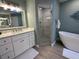 Bright bathroom featuring a walk-in shower with glass doors, sleek vanity, and contemporary finishes at 1137 Treasure Cay Ct, Punta Gorda, FL 33950