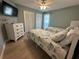Cozy bedroom with two twin beds, beach-themed bedding and bright natural light at 1137 Treasure Cay Ct, Punta Gorda, FL 33950