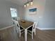 Cozy dining room with a table set for four, and a view of the outdoors at 1137 Treasure Cay Ct, Punta Gorda, FL 33950