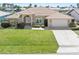 Charming single-story home featuring a tile roof, well-manicured lawn, and an attached two-car garage at 1137 Treasure Cay Ct, Punta Gorda, FL 33950