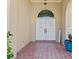 Inviting front entrance with double doors, tiled flooring, and decorative plants offering curb appeal at 1137 Treasure Cay Ct, Punta Gorda, FL 33950