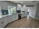 Bright kitchen with stainless steel appliances, white cabinetry, and quartz countertops at 1137 Treasure Cay Ct, Punta Gorda, FL 33950